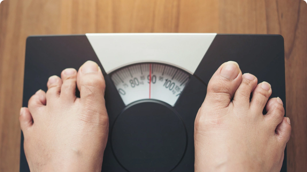 Hands over stomach in pain