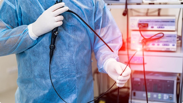 Hands over stomach in pain