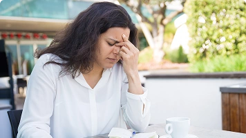 Woman lying on couch fatigued 