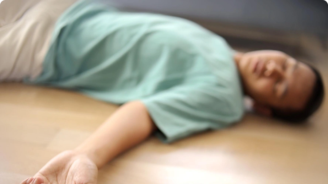 Woman lying unconscious on the floor.